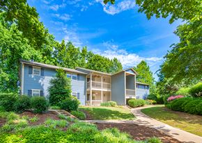 Chattanooga apartment for rent - a blue and white house with trees and a sidewalk