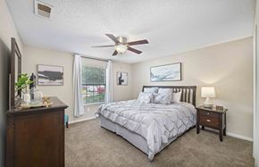 Chattanooga apartment for rent - a bedroom with a bed and a ceiling fan
