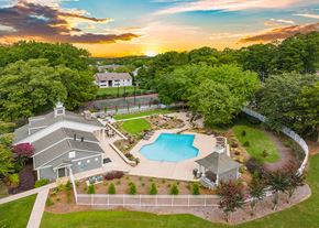 Huntsville apartment for rent - an aerial view of a pool and house with a sunset in the background