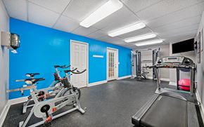 Hixson apartment for rent - a gym with exercise equipment and a blue wall