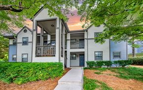 Hixson apartment for rent - a white apartment building with a sidewalk and trees