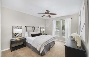 Hoover apartment for rent - a bedroom with a large bed and a ceiling fan