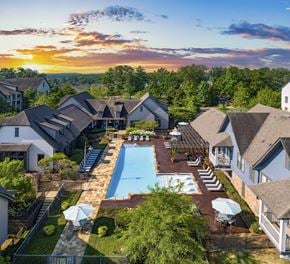 Hoover apartment for rent - arial view of a resort style swimming pool with umbrellas in a backyard