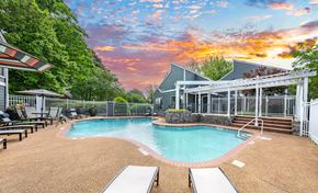 Memphis apartment for rent - A pool surrounded by a fence with a building in the background.