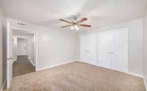 Memphis apartment for rent - an empty bedroom with a ceiling fan and white closets