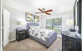 Memphis apartment for rent - A bedroom with a bed, nightstands, and a ceiling fan.