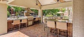 Memphis apartment for rent - a large outdoor kitchen with a bar and chairs