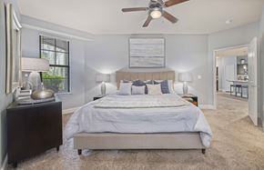 Kansas City apartment for rent - a bedroom with a bed and a ceiling fan