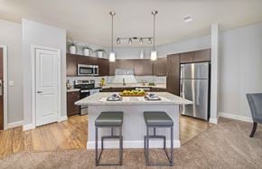 Kansas City apartment for rent - a kitchen with a marble counter top and stainless steel appliances