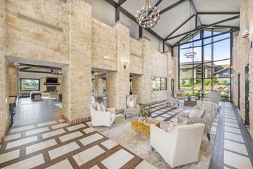 Overland Park apartment for rent - a large living room with a stone wall and a large lobby with furniture
