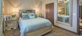 Overland Park apartment for rent - a bedroom with a bed and a mirror