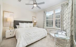 Nashville apartment for rent - a bedroom with a large bed and a ceiling fan