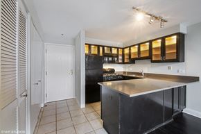 Winnetka apartment for rent - a kitchen with black appliances and a counter top