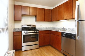 Chicago apartment for rent - A kitchen with wooden cabinets and stainless steel appliances.