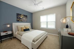 Allentown apartment for rent - a bedroom with a white bed and a blue accent wall