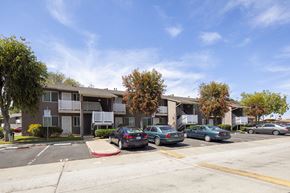 San Diego apartment for rent - an apartment building with cars parked in a parking lot