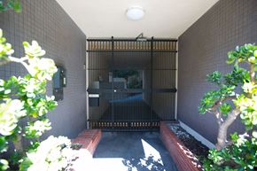 San Francisco apartment for rent - A small, dark room with a bench and a gate.