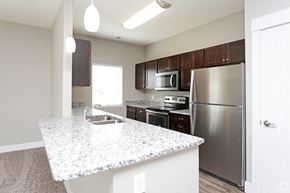 Lincoln apartment for rent - a kitchen with a granite counter top and stainless steel refrigerator
