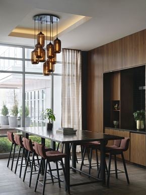 East Boston apartment for rent - a dining room with a black table and chairs and a large window