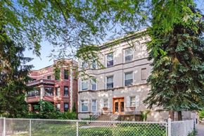 Chicago apartment for rent - the exterior of an apartment building with trees and a fence