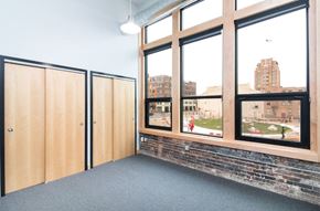 Sioux City apartment for rent - a room with large windows and a brick wall