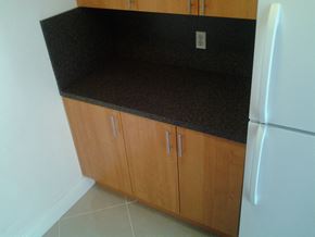 Miami apartment for rent - a kitchen with a counter top and a refrigerator