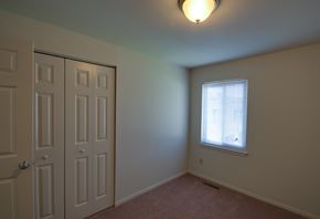 Baltimore apartment for rent - a bedroom with a window and a door and a closet