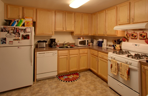Columbia apartment for rent - a kitchen with white appliances and wooden cabinets