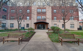 Baltimore apartment for rent - Exterior view of Park Heights Place senior apartment community in Baltimore, featuring beautifully landscaped grounds, gated courtyard, and newly renovated affordable housing for adults age 62 and better.