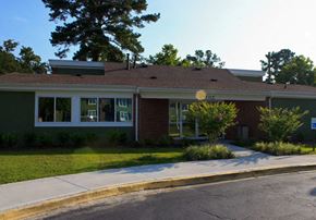 Hinesville apartment for rent - A small building with a green lawn in front.