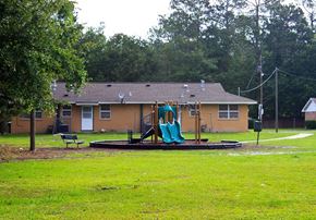 Hinesville apartment for rent - a playground in a park in front of a house
