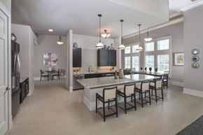 Arcola apartment for rent - A kitchen with a large island and a refrigerator on the left.