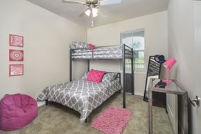 Arcola apartment for rent - A bedroom with a bunk bed and a pink chair.