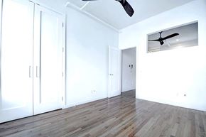 New York apartment for rent - an empty room with white walls and a ceiling fan