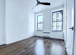 New York apartment for rent - an empty living room with hardwood floors and a window