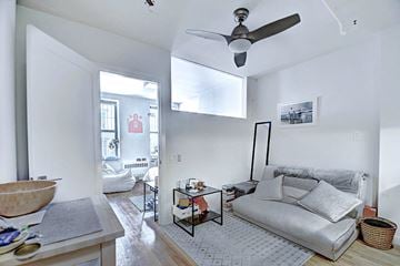 New York apartment for rent - a living room with a couch and a ceiling fan