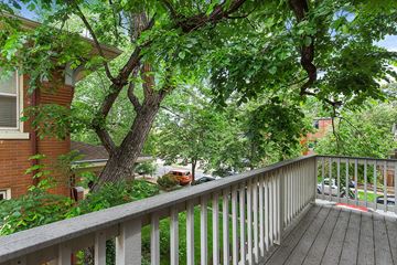 Denver apartment for rent - a balcony with a wooden railing and trees