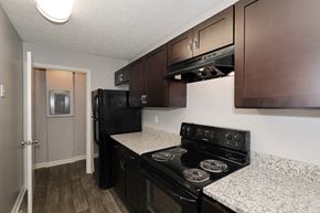 Norcross apartment for rent - a kitchen with black appliances and granite counter tops