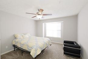Norcross apartment for rent - a bedroom with a bed and a ceiling fan