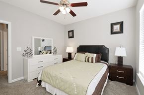 Norcross apartment for rent - a bedroom with a large bed and a ceiling fan