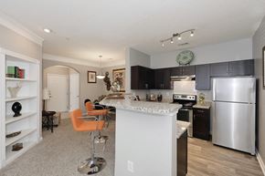 Norcross apartment for rent - the view of a kitchen and dining area with stainless steel appliances and a granite counter
