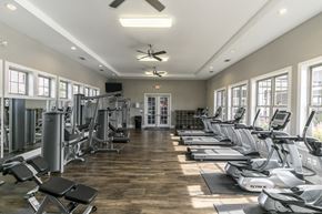 San Antonio apartment for rent - a gym with cardio machines and chairs and windows