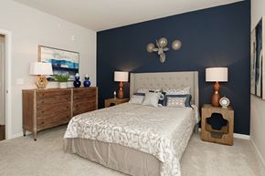 San Antonio apartment for rent - a bedroom with a bed and a blue accent wall