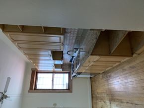 Chicago apartment for rent - an empty kitchen with wooden floors and cabinets and a sink