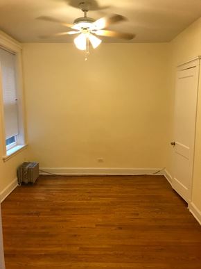 Chicago apartment for rent - a empty room with a ceiling fan and a window