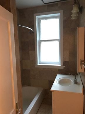 Chicago apartment for rent - a bathroom with a sink and a tub and a window