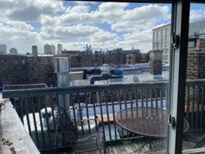 Chicago apartment for rent - a balcony with a view of a city and a swimming pool