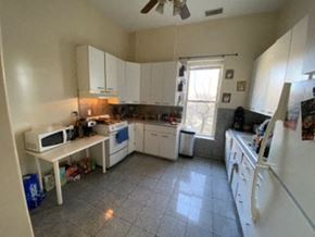Chicago apartment for rent - a kitchen with a stove and a microwave and a sink