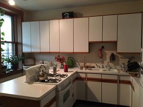 Chicago apartment for rent - a kitchen with white cabinets and a stove and a sink