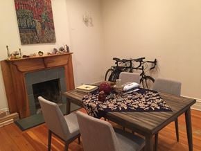 Chicago apartment for rent - a dining room with a table and chairs and a fireplace